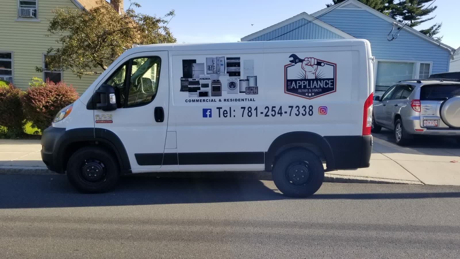 The Elite Appliance van parked on a residential street, the company badge and phone number on the side panel, above the words COMMERCIAL & RESIDENTIAL